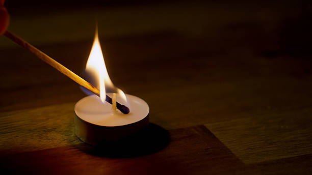 istock Lighting a candle with a match stick 2237541266