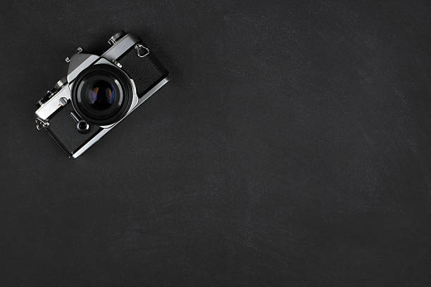 istock Retro Photo Camera on Black Textured Background 2237545041