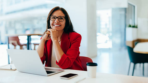 istock Confident businesswoman smiling while working in a bright office environment 2237546648