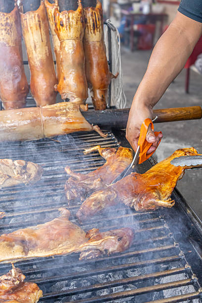 Typical food of Ecuador: guinea pig roasting on the grill, prepared with traditional Andean techniques that preserve cultural essence and offer a unique gastronomic experience.