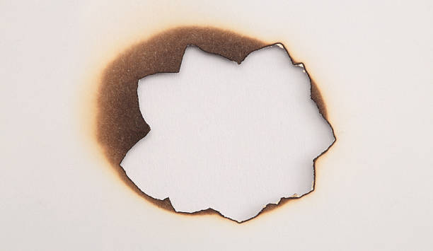 istock Burned Torn, ripped paper pieces wave lines hole frame. Beige, brown copy space texture background 2237548762