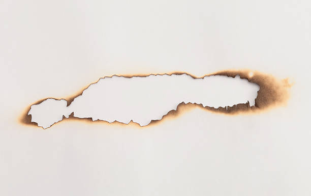 istock Burned Torn, ripped paper pieces wave lines hole gap frame. Beige, brown copy space texture background 2237548775