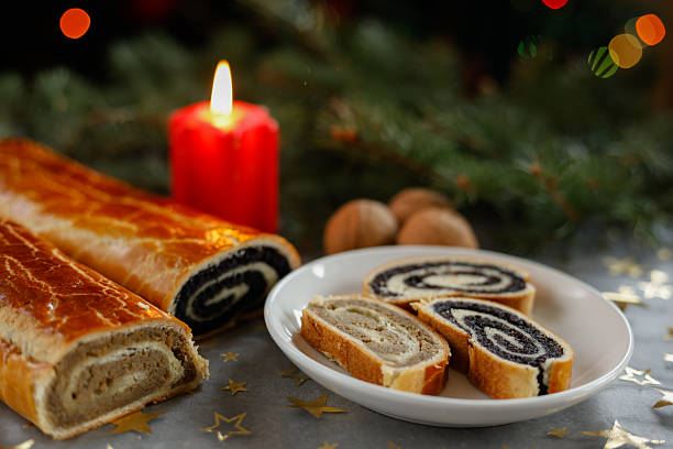 istock Sliced Christmas walnut and poppy seed rolls with candle 2237550324