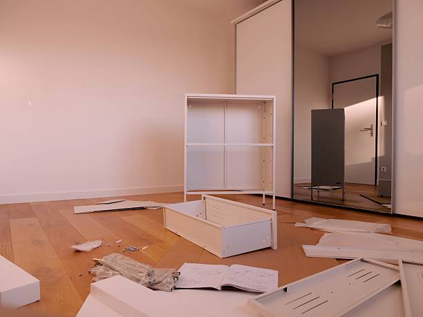 istock Flat-pack furniture assembly in modern room 2237550335