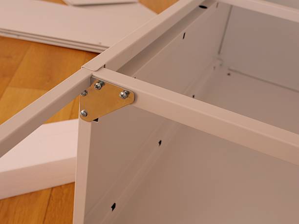 istock Flat-pack furniture assembly in modern room 2237550384