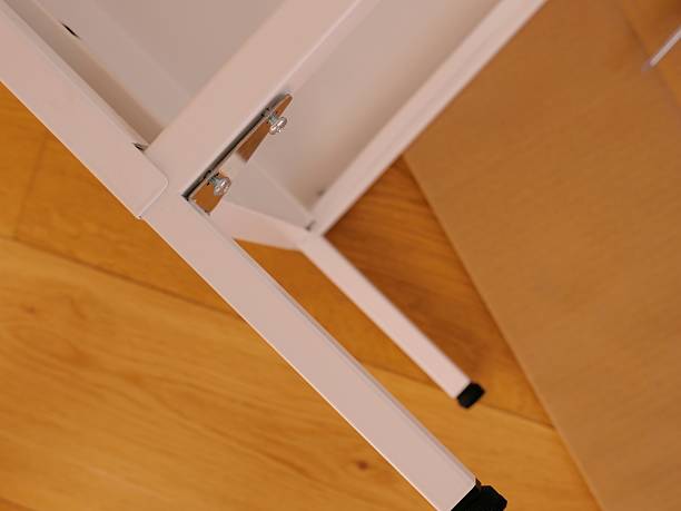 istock Flat-pack furniture assembly in modern room 2237550397