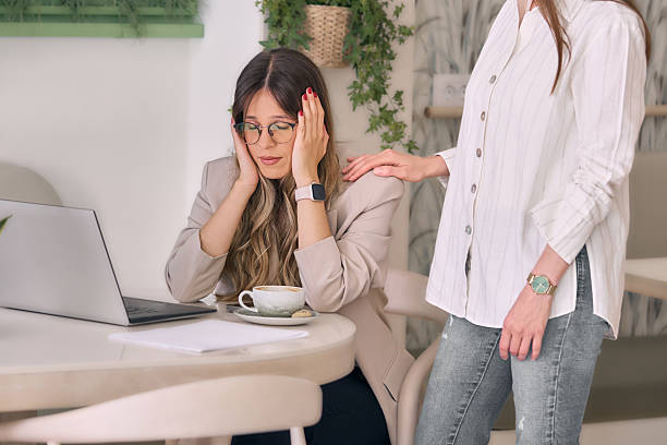 istock Young woman comforts her distressed coworker in office 2237550678