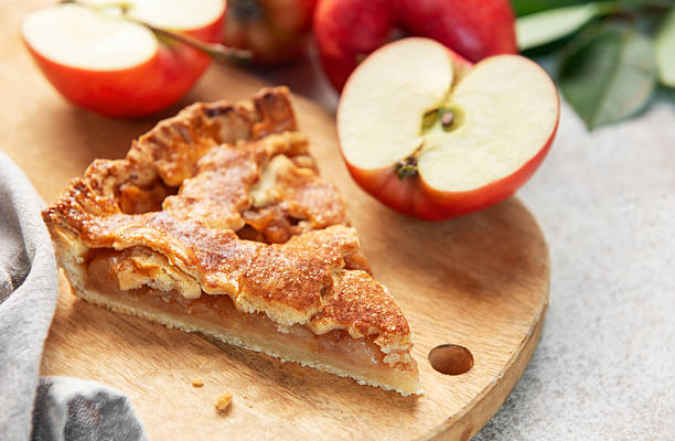istock Apple pie slice on wooden board with apples 2237551903