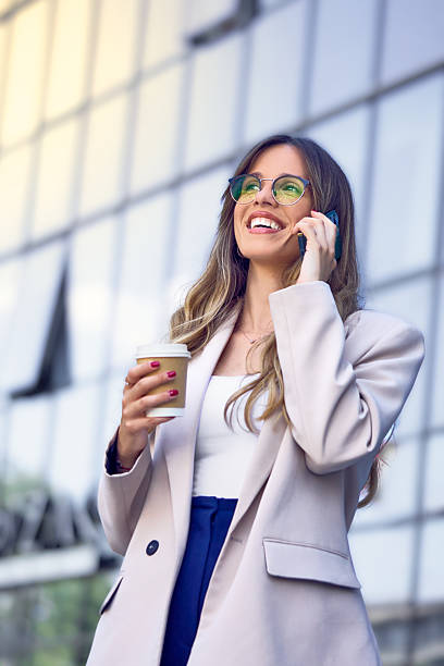 istock Confident female entrepreneur discussing on cellphone outside. 2237552322