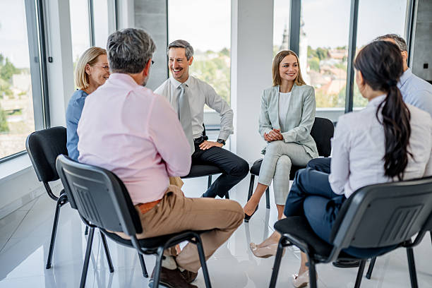 istock Business people sitting in circle discussing ideas 2237555778