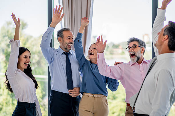 istock Business people celebrating success with raised arms 2237556283