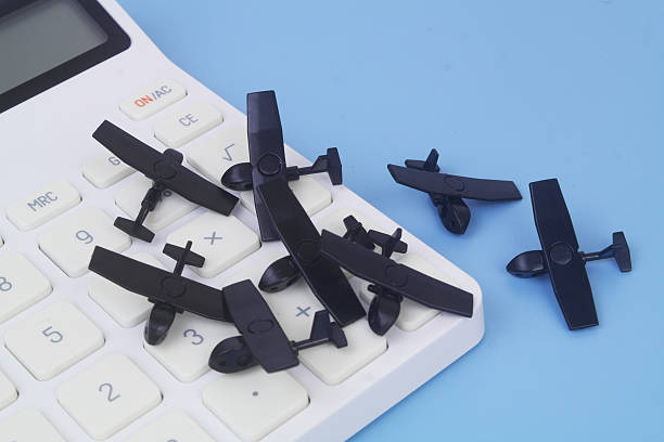 istock Military drone models on calculator on blue background. 2237556556