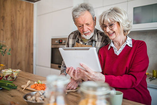 istock Elderly couple cooking together using online recipe 2237556668
