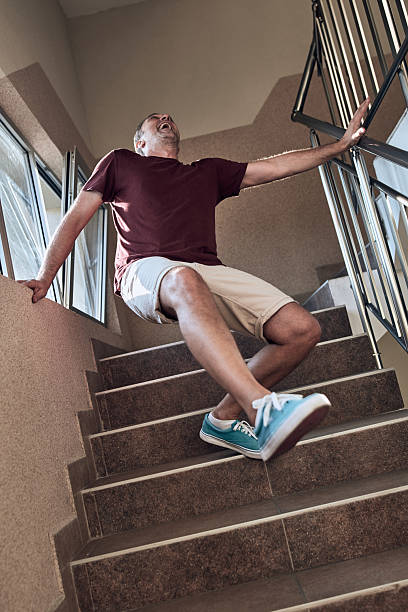 istock Man having an injury on the staircase. 2237556758