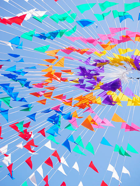 istock Colorful flags and streamers create a vibrant display against a clear blue sky. 2237561693