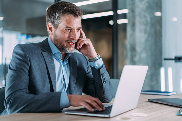 istock Successful businessman in modern office working on laptop. 2237562067