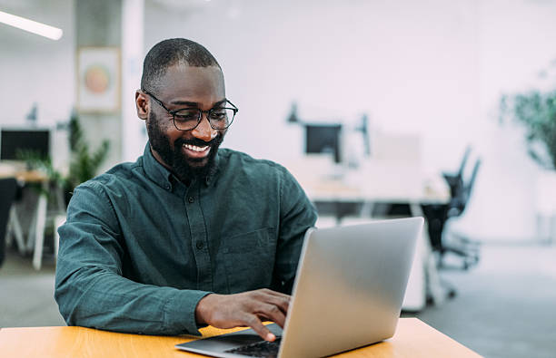 istock Successful businessman in modern office working on laptop. 2237562103