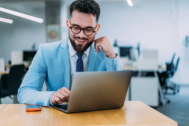 istock Successful businessman in modern office working on laptop. 2237562110