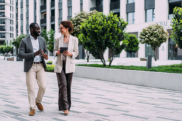 istock Business people using digital tablet outdoors. 2237563010