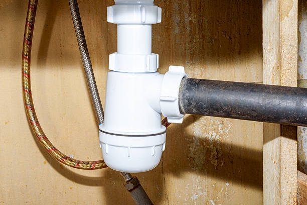 istock A new plumbing trap under the kitchen sink and old drain pipes. 2237564841