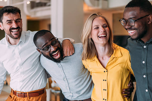 istock Excited coworkers embracing each other during a celebration in the office. 2237565703
