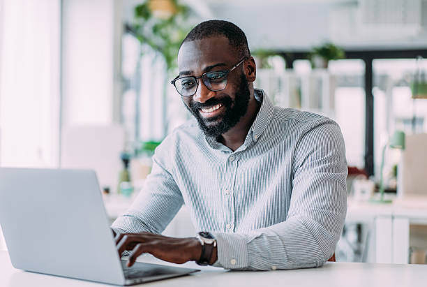 istock Successful businessman in modern office working on laptop. 2237565759