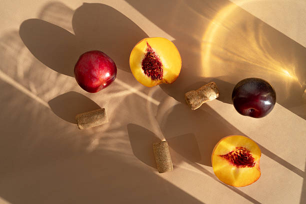 istock Various wine glasses and peaches long shadow from the sun on a light beige background. Wine tasting or summer vacation concept. Beautiful fruit background 2237566456