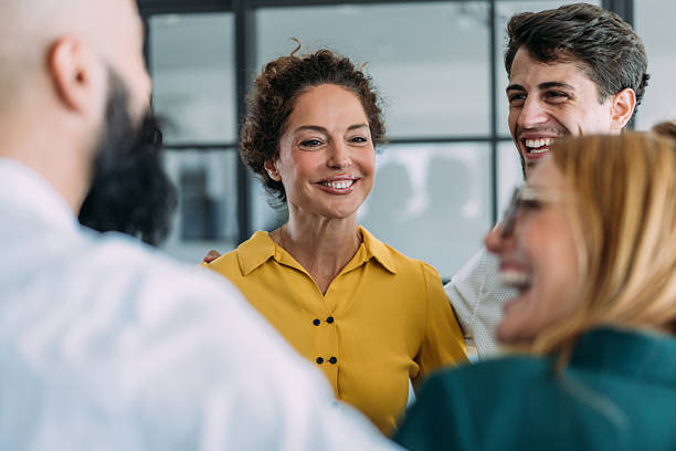 istock Excited coworkers embracing each other during a celebration in the office. 2237568272