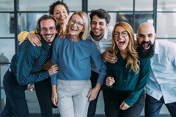 istock Excited coworkers embracing each other during a celebration in the office. 2237568285