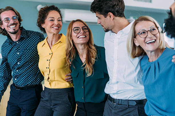 istock Excited coworkers embracing each other during a celebration in the office. 2237568292