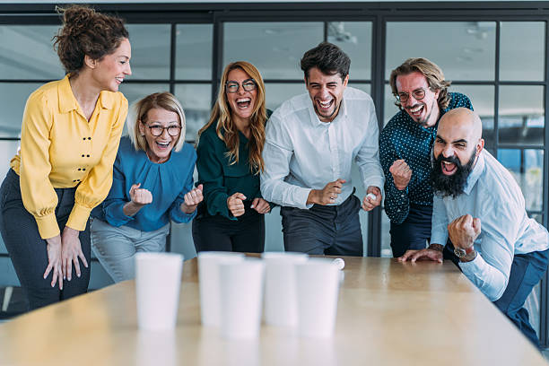 istock Colleagues playing beer pong in the office. 2237568326