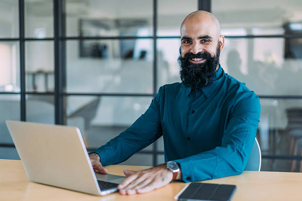 istock Successful businessman in modern office working on laptop. 2237568348
