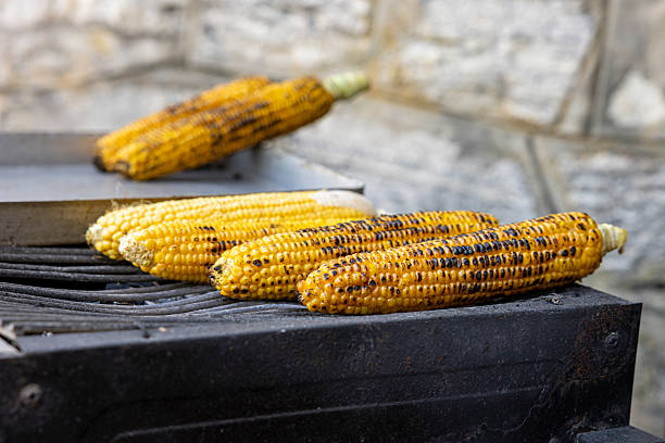 Market stall in Mexico City with a close view of roasted corn cob.