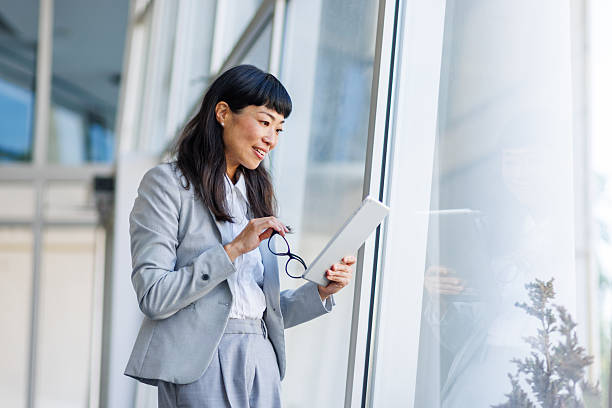 istock Asian businesswoman using digital tablet in modern office 2237570979