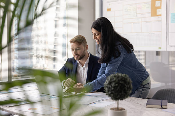 istock Diverse couple of business colleagues working on Internet project 2237571130