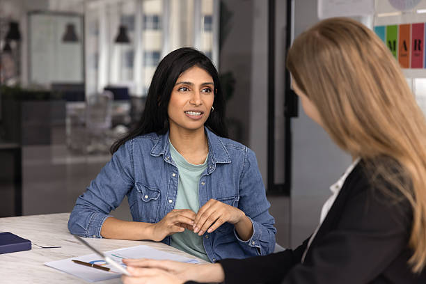 istock Two young diverse company colleagues talking at workplace office table 2237572957