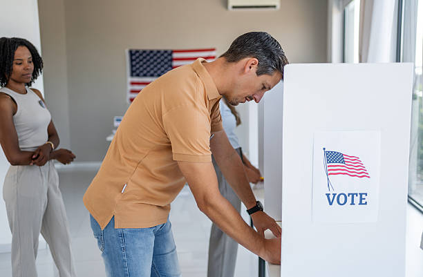 istock People voting in election at polling place 2237574797
