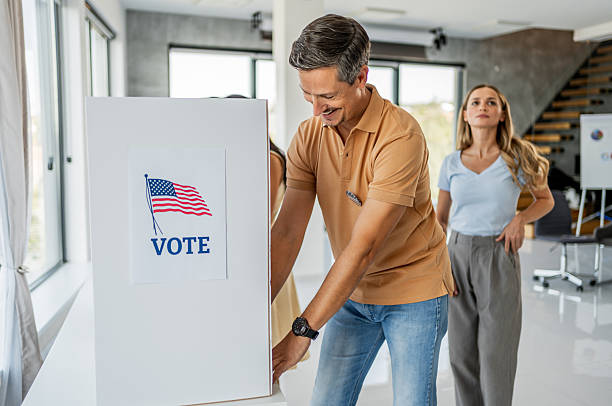 istock A man casting a ballot at a polling station for the US election 2237574876