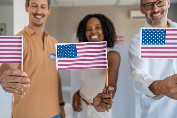 istock Diverse group of proud voters holding usa flags 2237578202