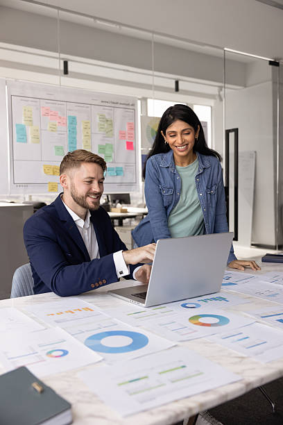 istock Two positive diverse millennial colleagues analyzing online marketing sales 2237578231