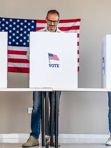 istock Man voting in booth at polling place 2237578524