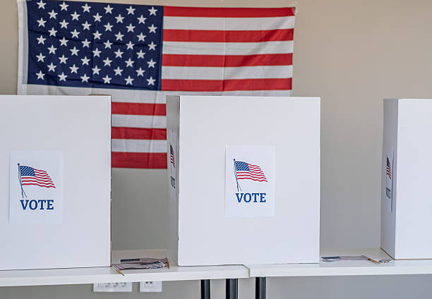 istock Voting booths with American flag demonstrating democratic election process 2237578527