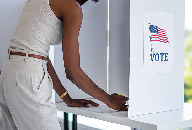 istock African American woman voting at polling booth 2237578686