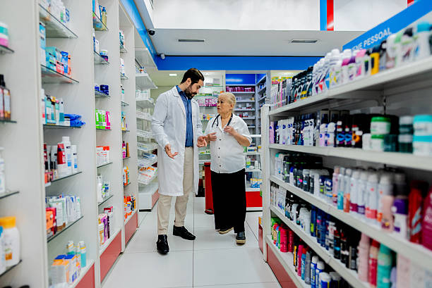 Pharmacists coworkers talking during work at pharmacy
