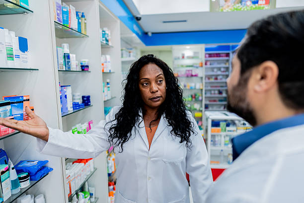 istock Mature pharmacist woman talking with customer at pharmacy 2237580110