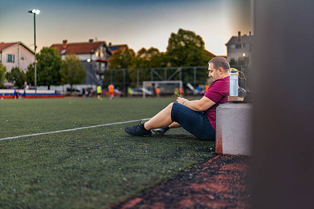 istock Overweight man taking a break of training and using mobile phone. 2237580279