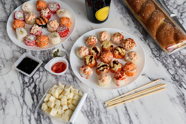 Savoring Delicious Sushi and an Array of Snacks Artfully Presented on a Marble Table