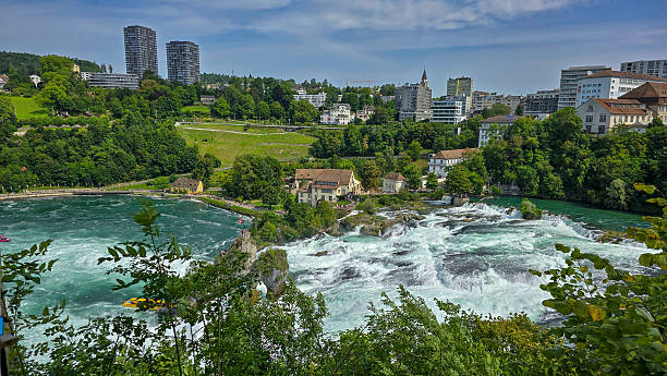 istock Powerful Europe's largest waterfall Rhine Falls, surrounded by cliffs and greenery under a blue sky, creating a dynamic and dramatic scene. Schaffhausen, Switzerland. 2237583646
