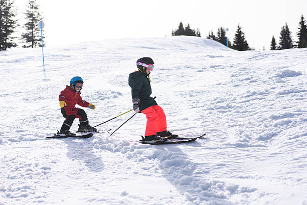 istock Children skiing downhill on sunny winter day 2237583784