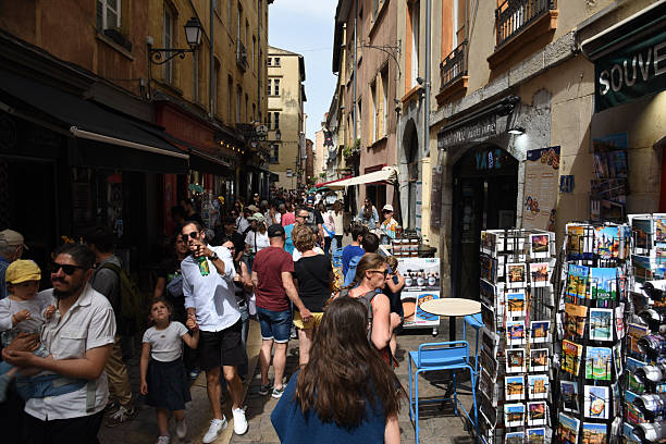 Rue Saint-Jean is a paved pedestrian street in the Vieux Lyon district, in the 5th arrondissement of Lyon. The image shows the street with several pedestrians.